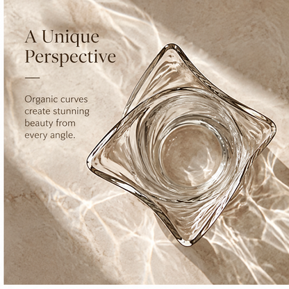 Close-up of the sweeping glass contours and outward-pointed curve