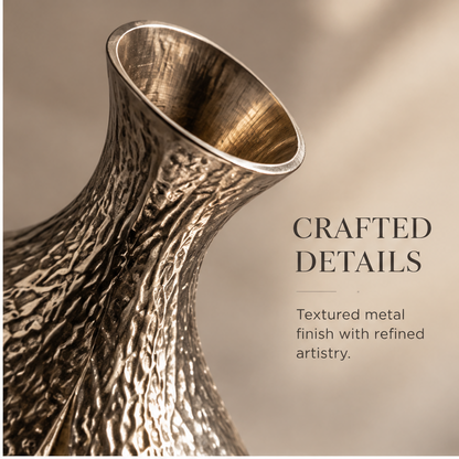 Ring-shaped metal vase styled with an airy branch arrangement on a console